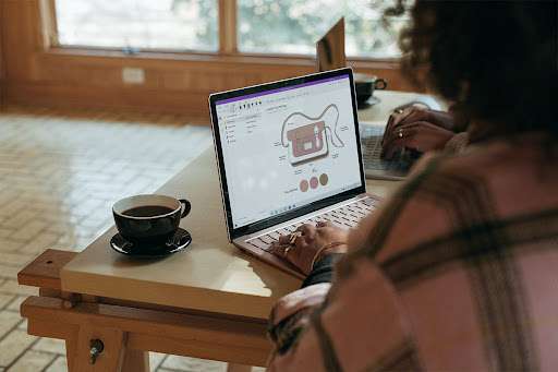 Two women working on their laptops.